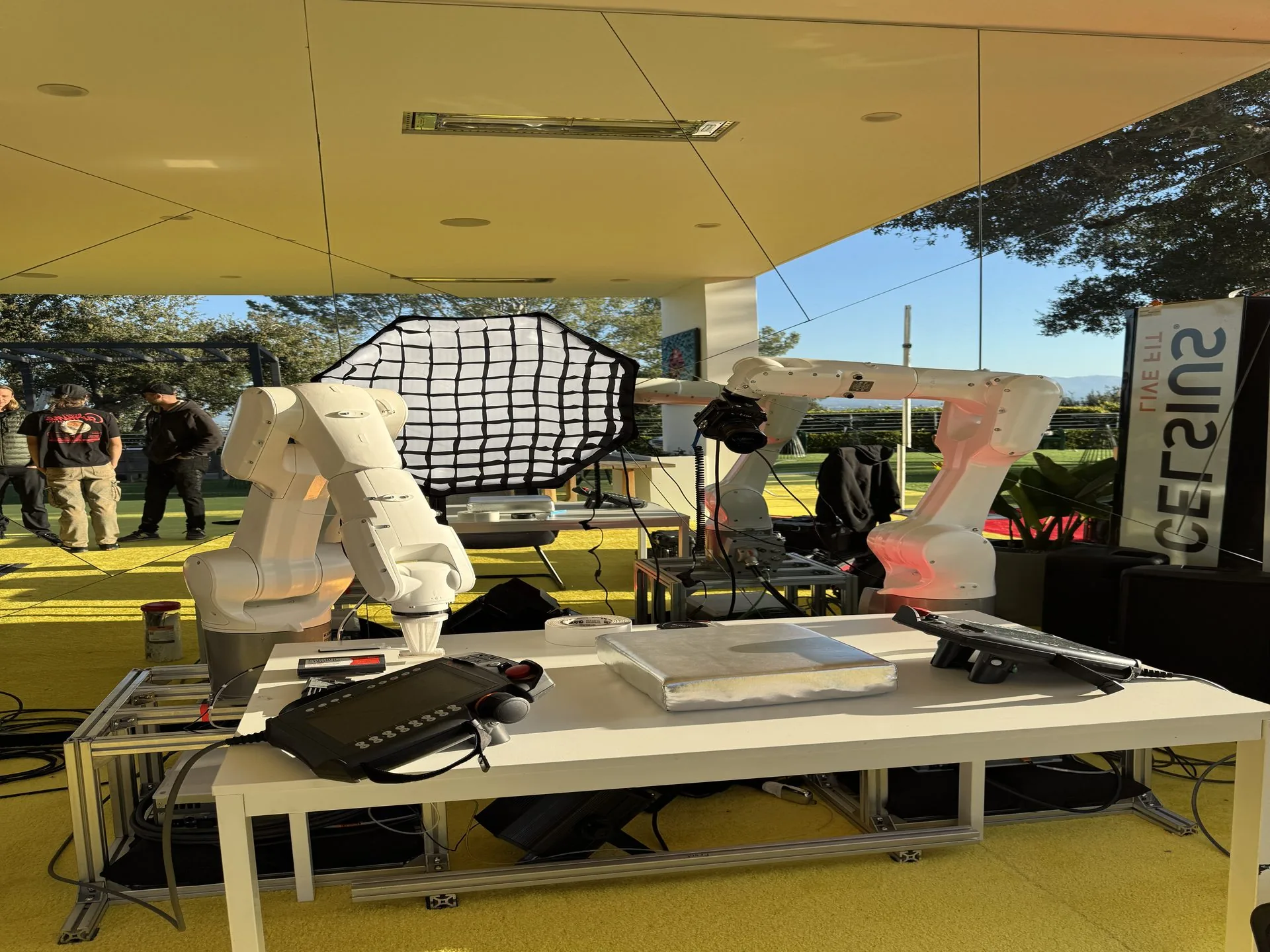 RoboCam robotic camera arm filming guests in front of the a studio film key art