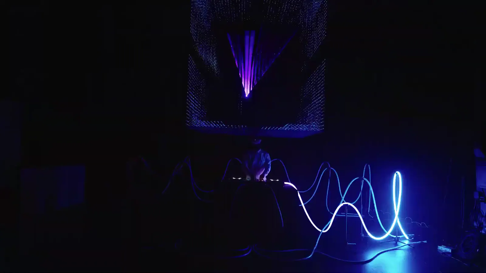 Custom DJ stage with 360° light tubes and kinetic rings